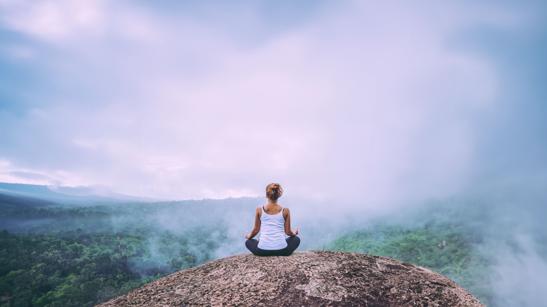 Asian women relax in the holiday. Play if yoga. On the Moutain rock cliff